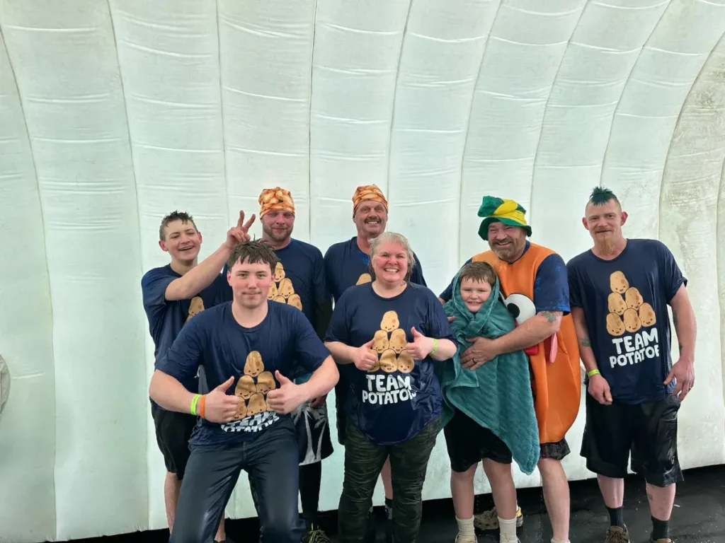Group posing together indoors in Team Potato shirts and costumes, after taking the plunge