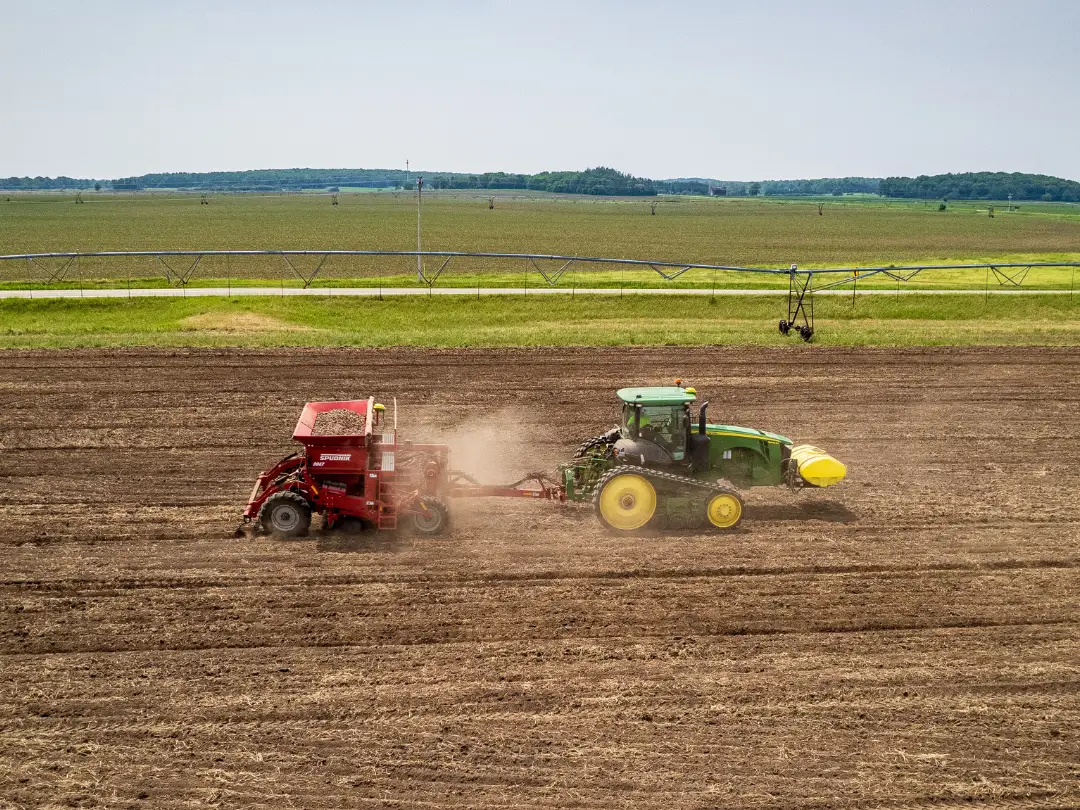 Tractors working together in cultivated field