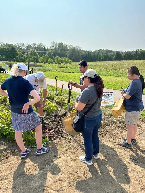 People gathered outdoors during farm field demonstration