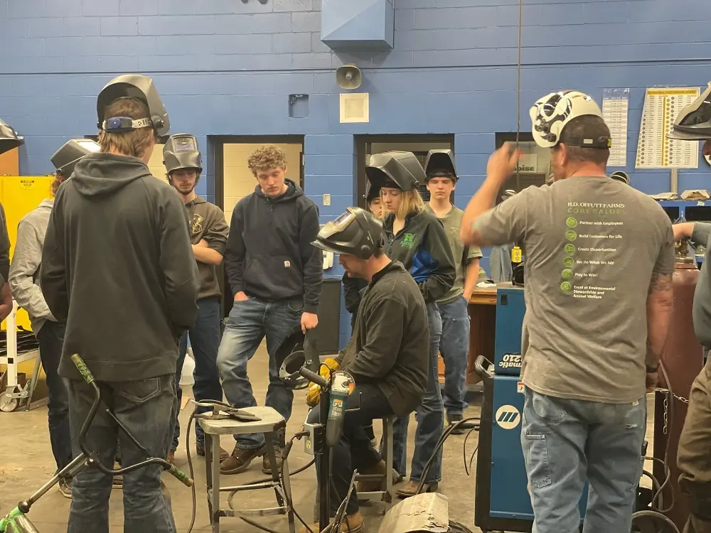 People working together in welding workshop