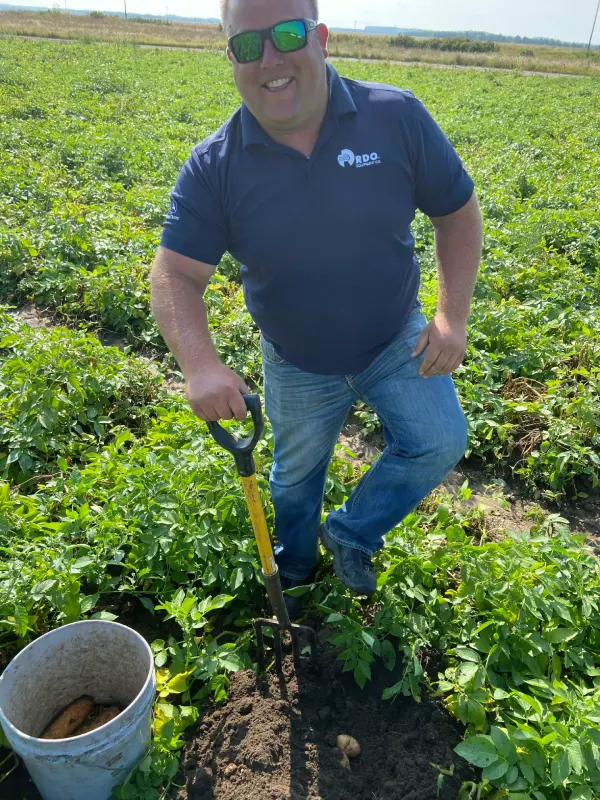 Shawn Nelson smiling while working in a field