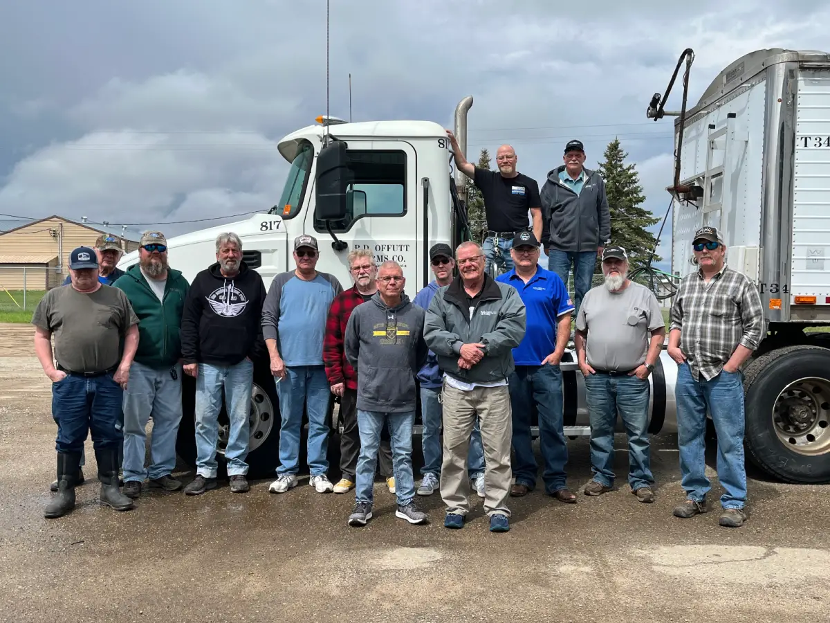 Veterans from R.D. Offutt posing in front of a truck