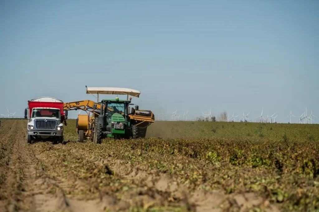 Farm machinery working across crop field