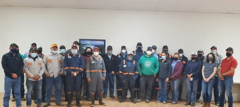 Group posing indoors in work uniforms