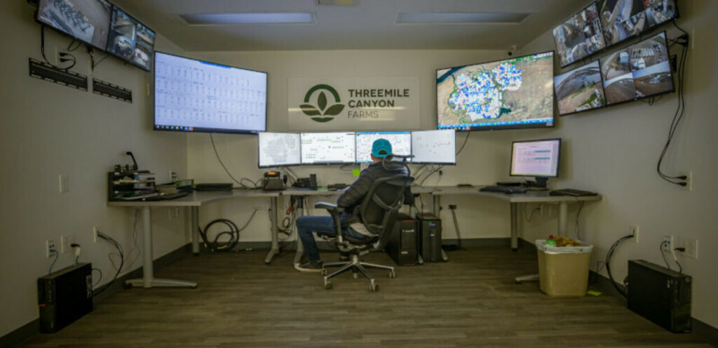 Person monitoring agricultural systems in control room