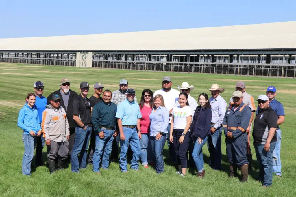 Group standing together outdoors in grassy field