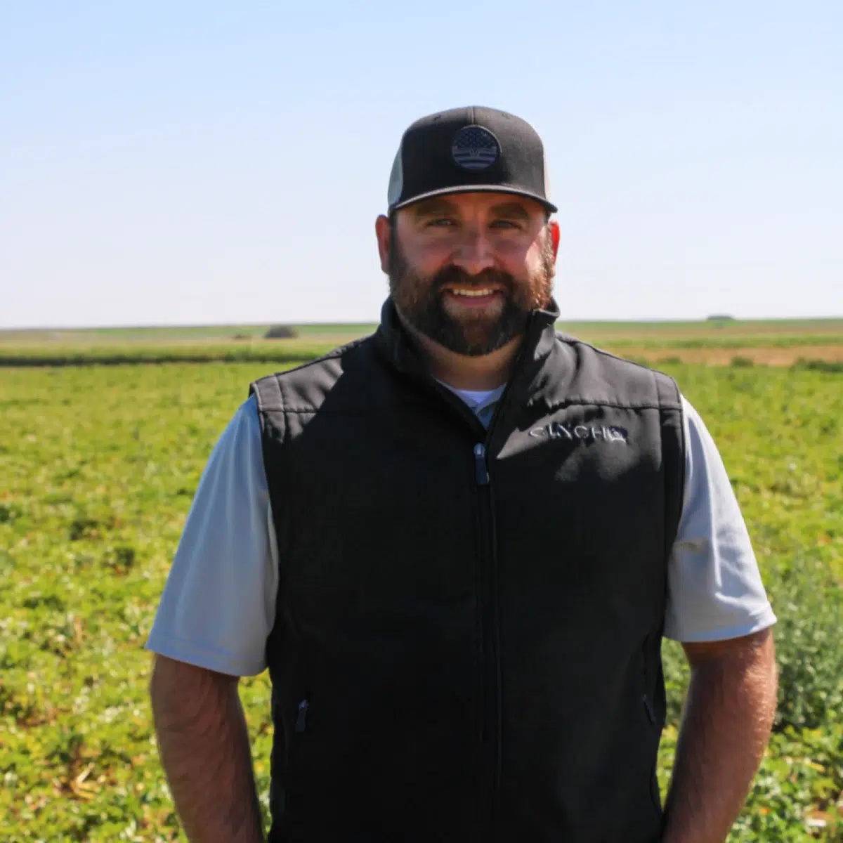 Man standing in green agricultural field