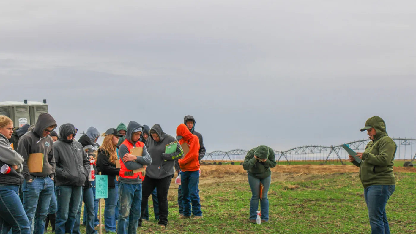 Group gathered in agricultural field during tour