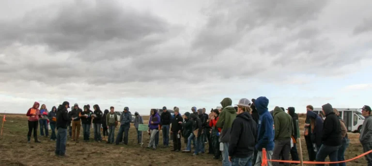 Crowd gathered outdoors under cloudy sky