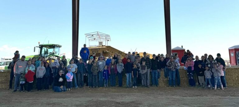 Large group gathered under open-sided structure