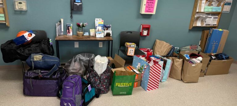 Donated supplies and gift bags arranged indoors