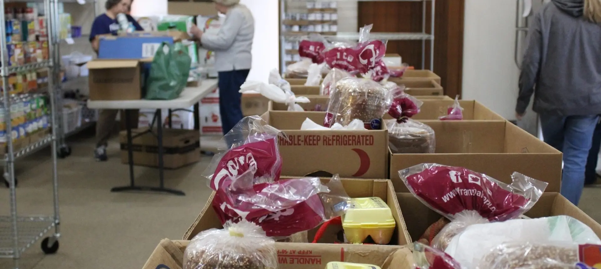 Boxes of packaged food and produce indoors