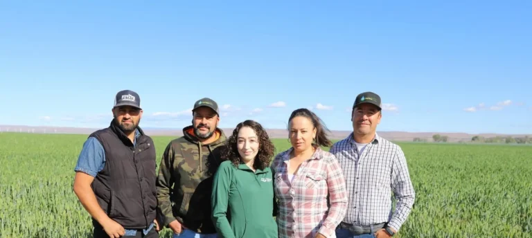 Group posing together outdoors in field
