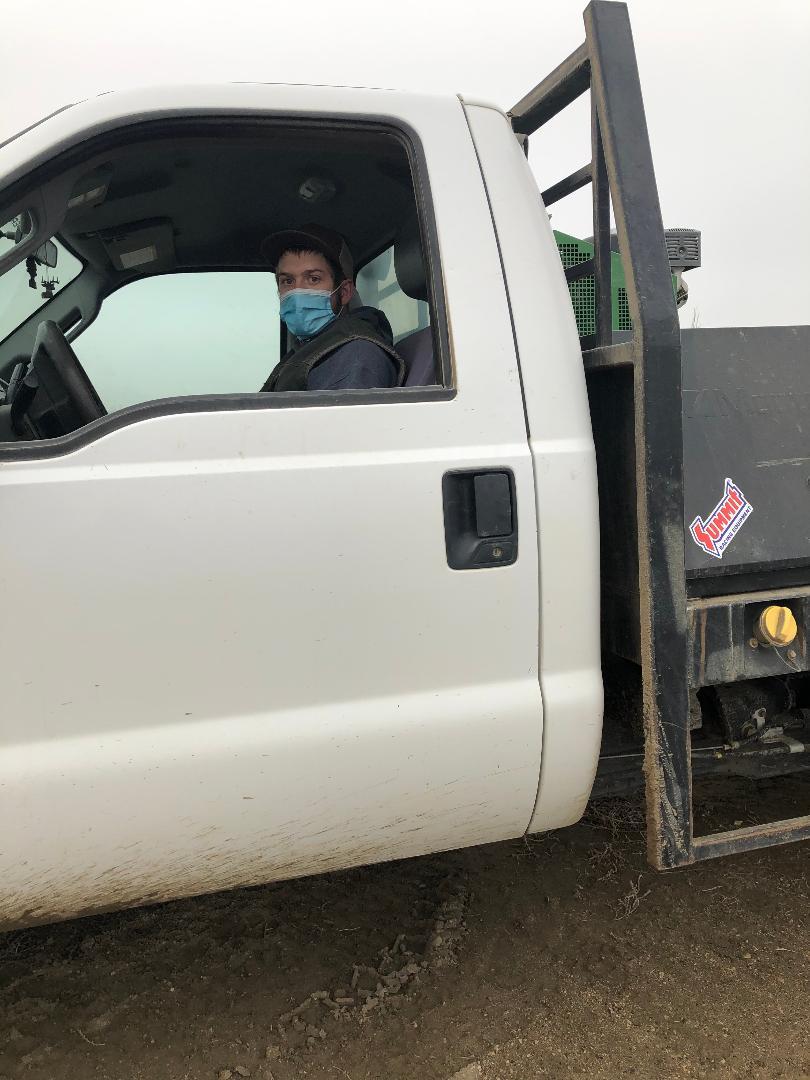 Person sitting inside white utility vehicle