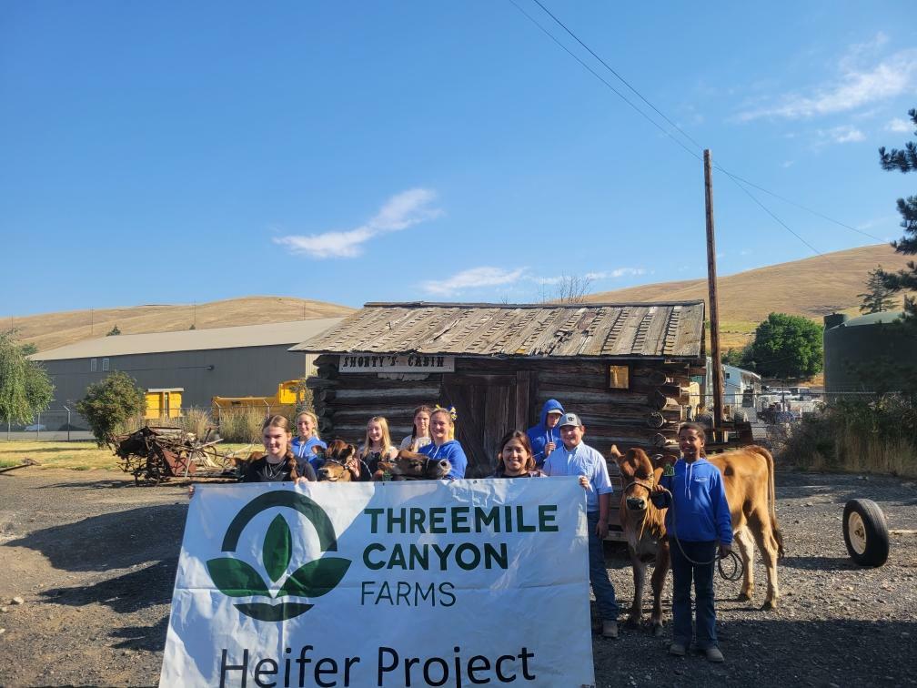 Community group standing beside project sign outdoors