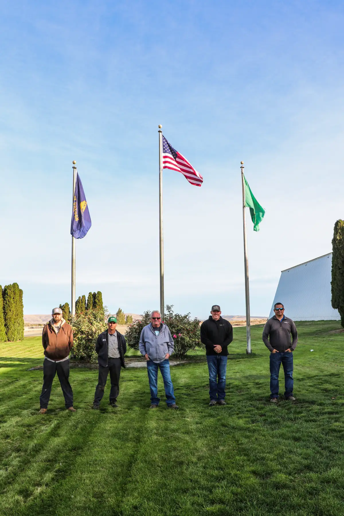 Veterans from Threemile, in front of flags.
