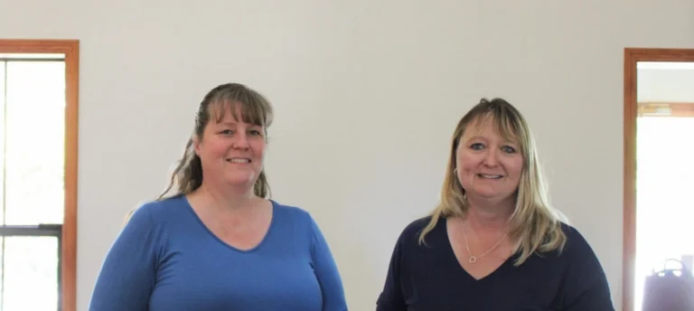 Two women smiling indoors