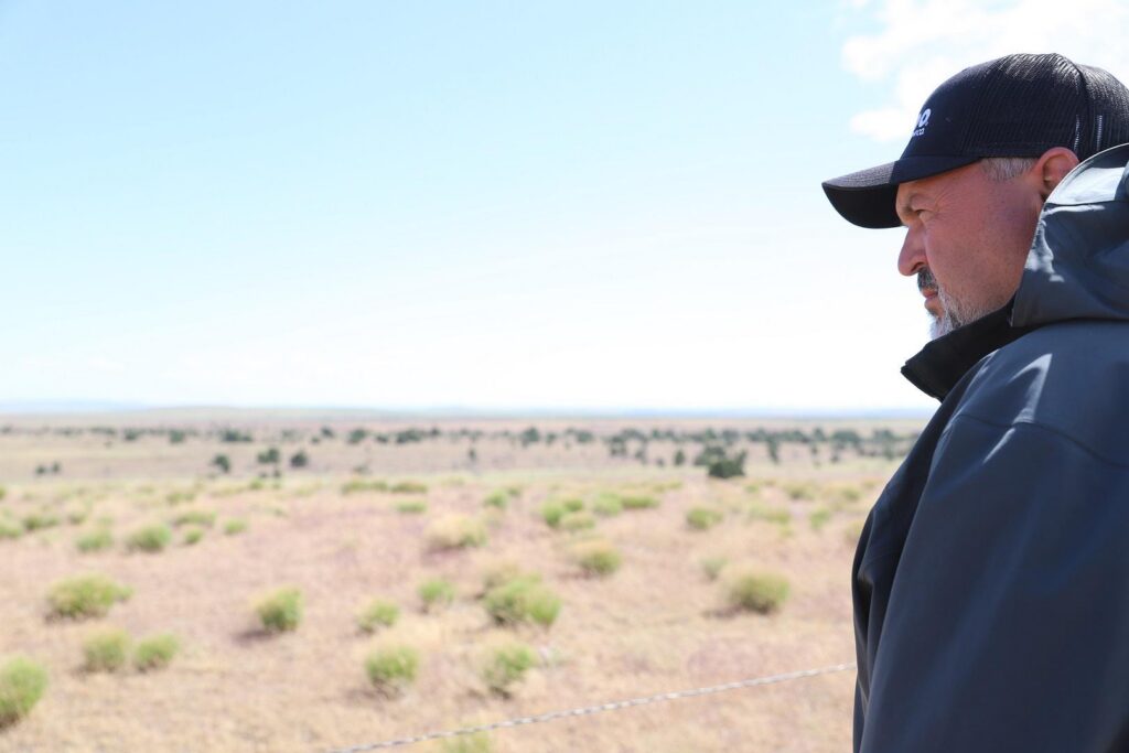 Man standing in dry agricultural field