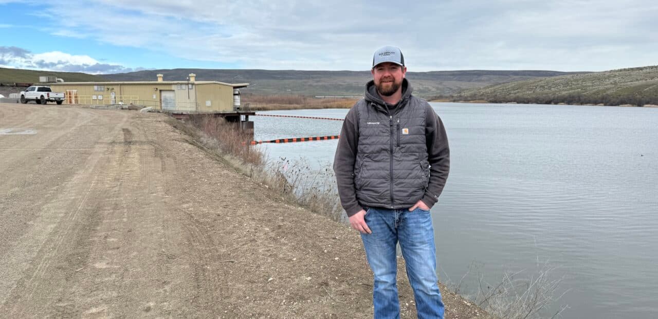 Man standing beside reservoir