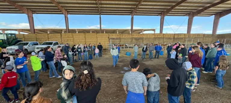 Group gathered inside livestock barn