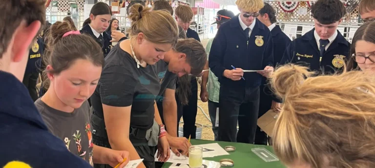Students participating in hands-on agricultural activity indoors