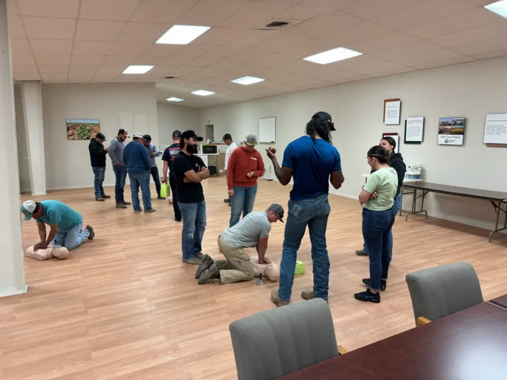 Group standing during CPR indoor workshop activity