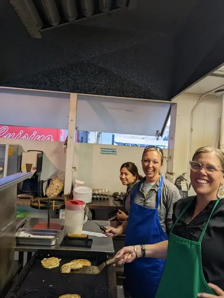 Volunteers working inside food booth