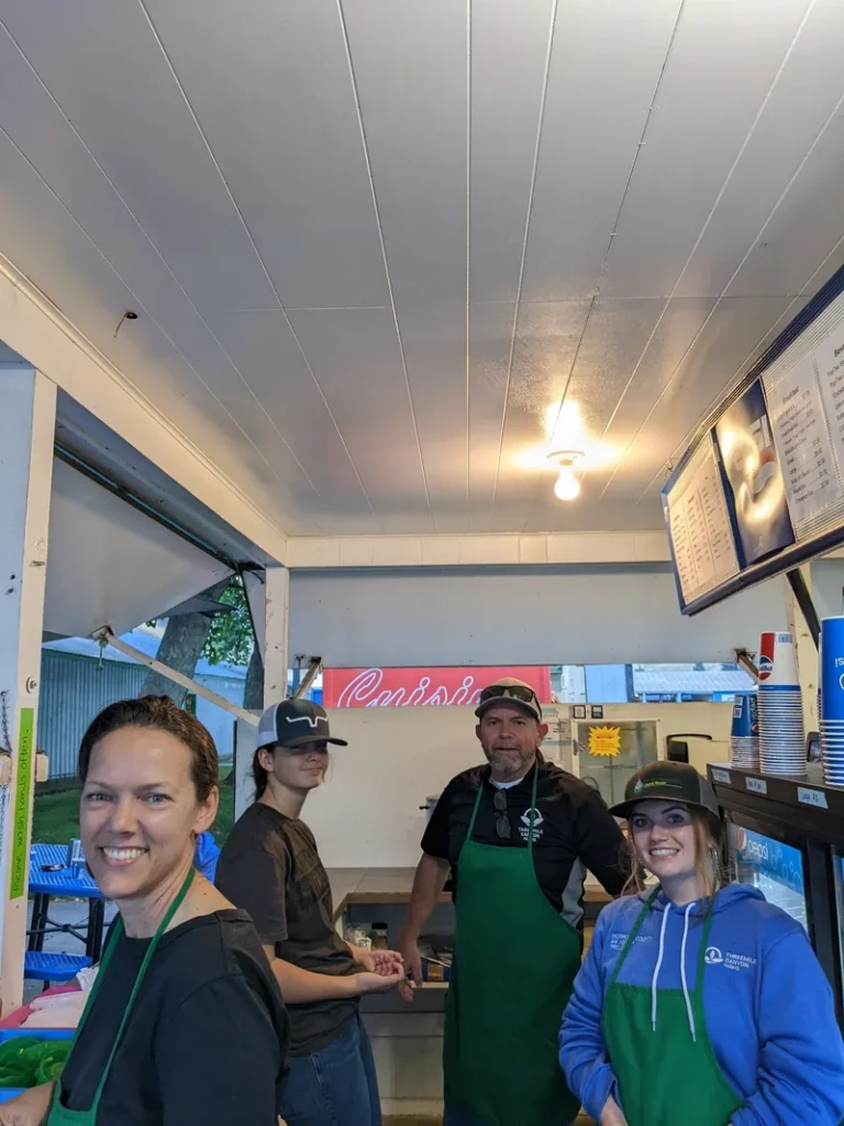 Workers serving food at booth