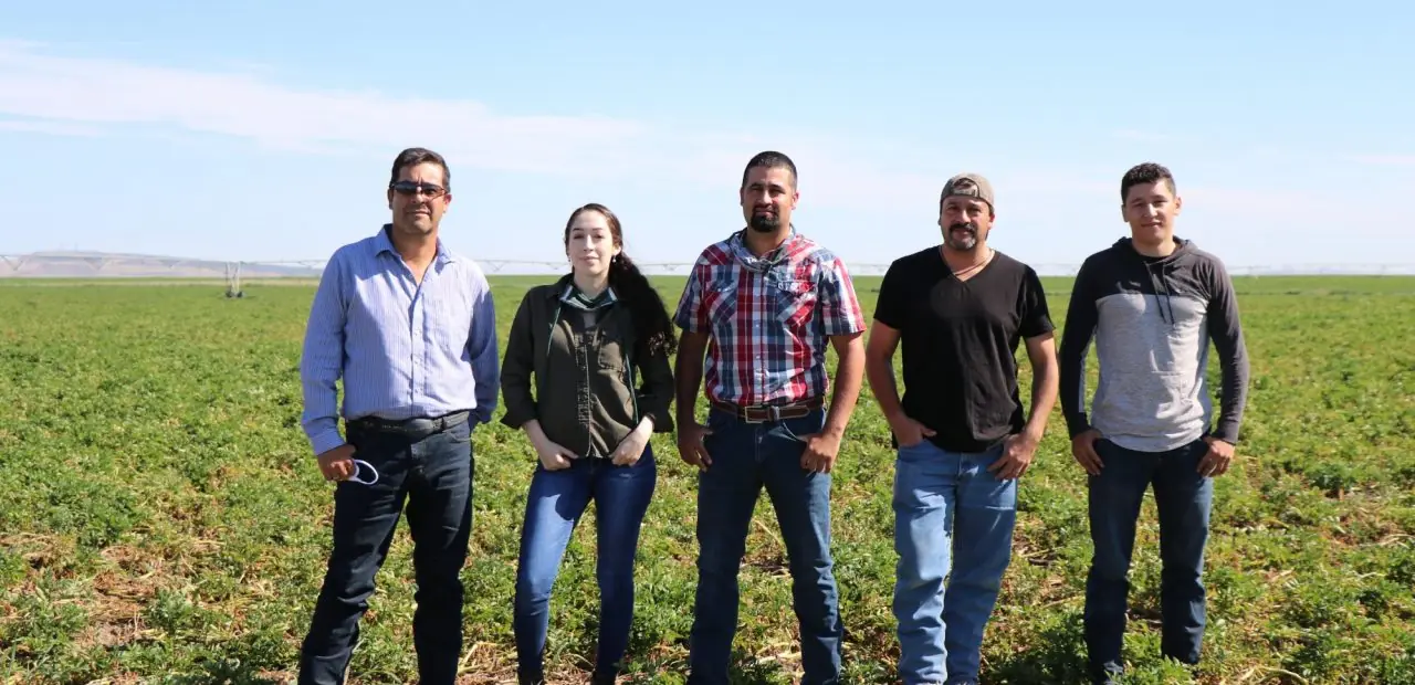 Madigral family posing in front of field