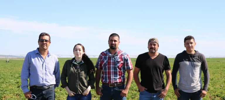 Madigral family posing in front of field